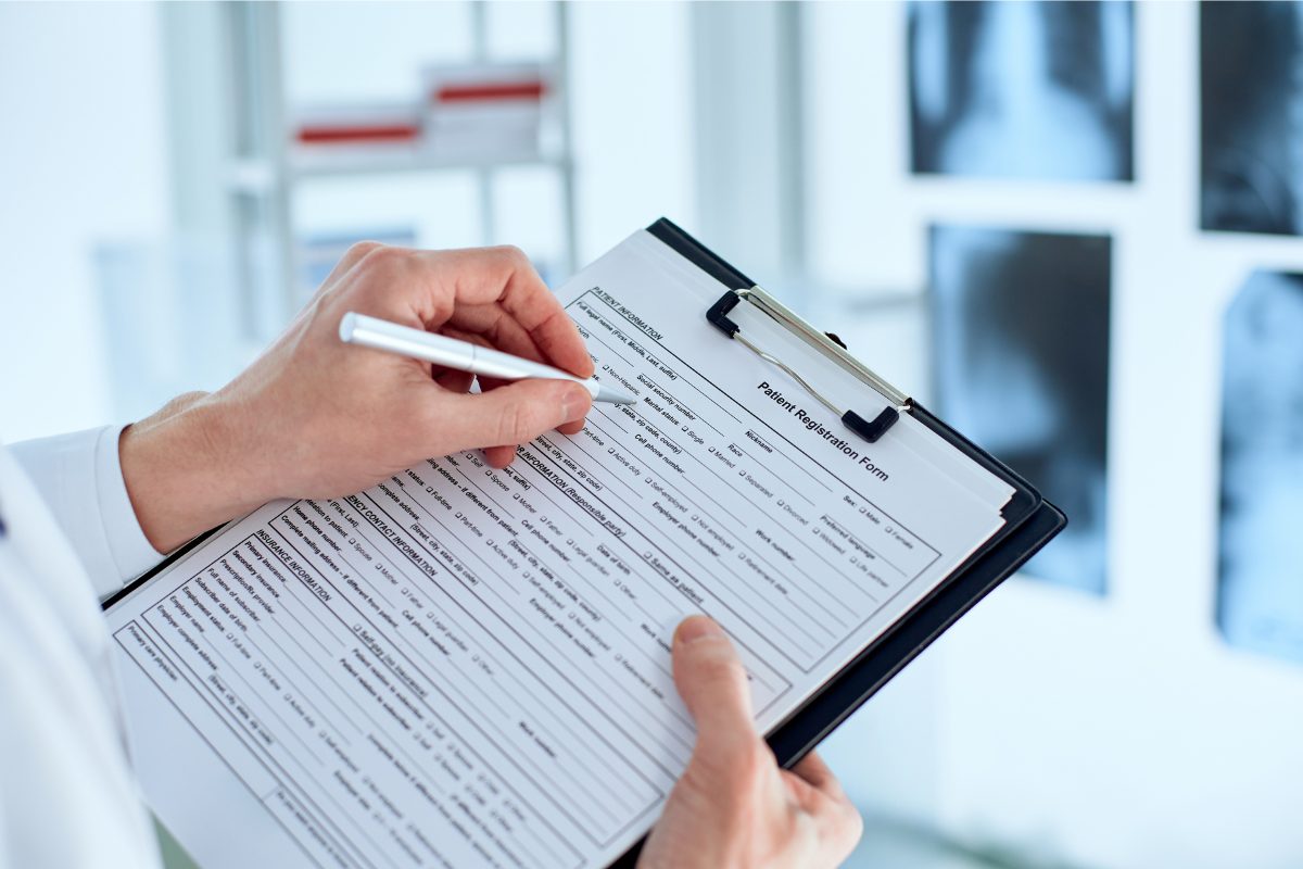A new patient filling out a registration and intake form for mental health services