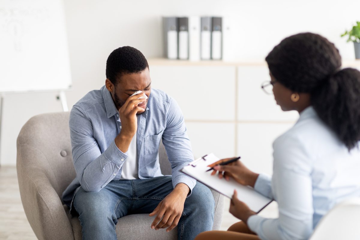 Therapist meeting with a client experiencing depression during a counseling session focused on assessment and treatment planning.