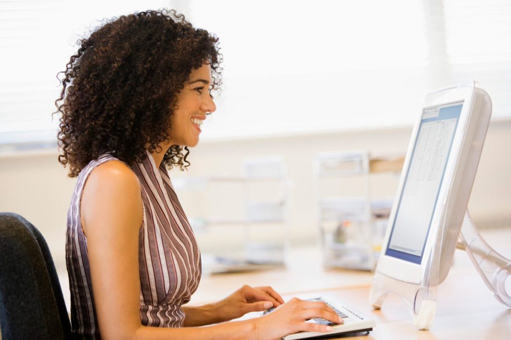 Mental Health Counselor typing therapist notes on a computer