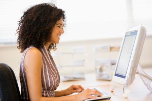 Mental Health Counselor typing therapist notes on a computer