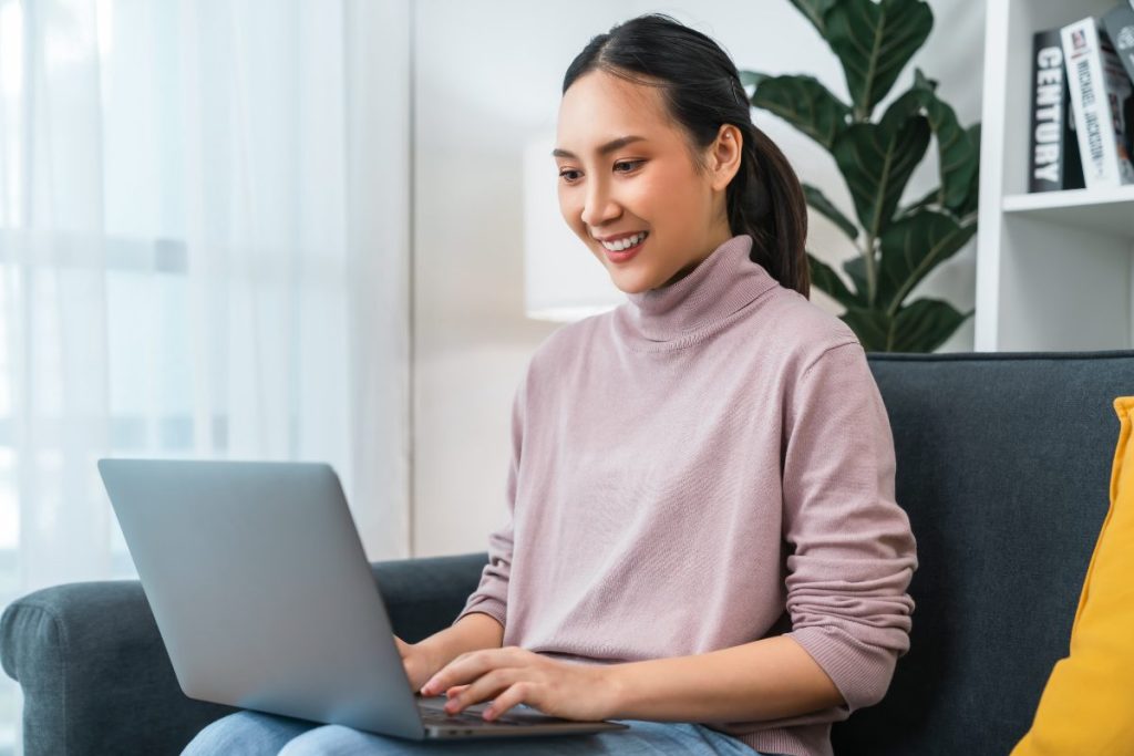 Therapist working on a laptop exploring passive income ideas for therapists and mental health professionals