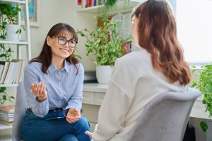 female psychologist counselor working young woman