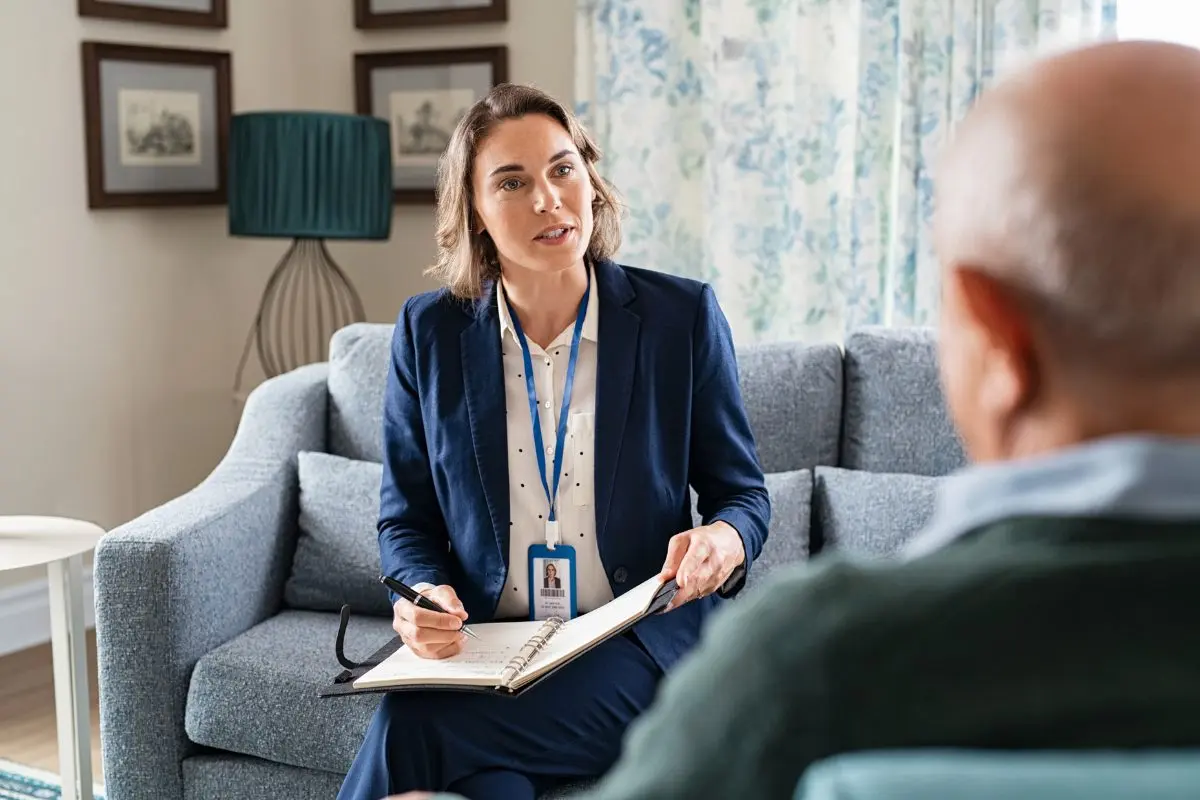 Social worker meeting with a client while using case management and behavioral health documentation software