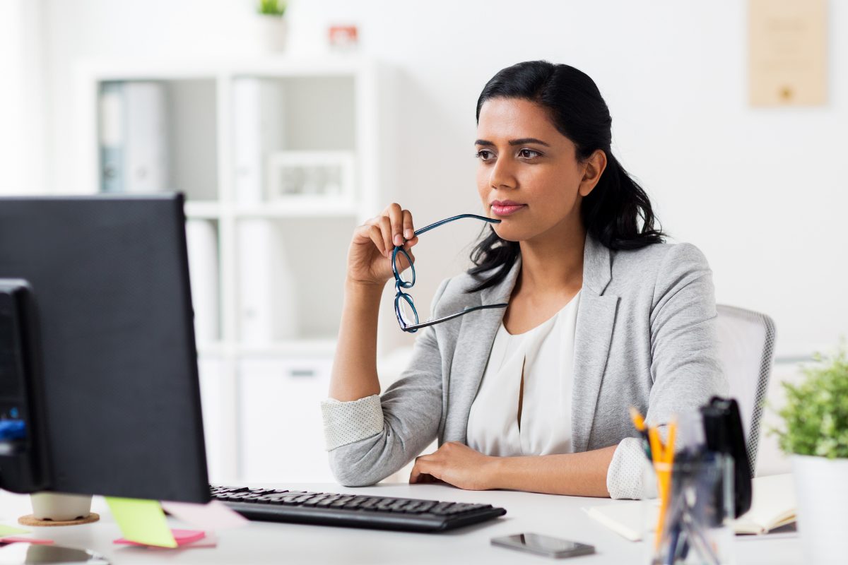 Behavioral health professional reviewing electronic health record options on computer, comparing EHR and EMR systems for practice management and care coordination.
