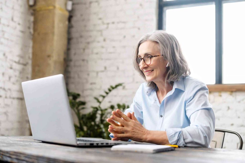 Therapist reviewing mental health practice management software in a private practice office