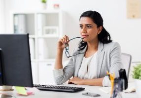 Behavioral health professional reviewing electronic health record options on computer, comparing EHR and EMR systems for practice management and care coordination.