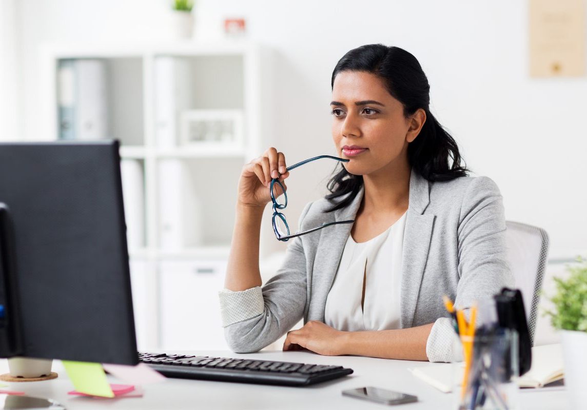 Behavioral health professional reviewing electronic health record options on computer, comparing EHR and EMR systems for practice management and care coordination.