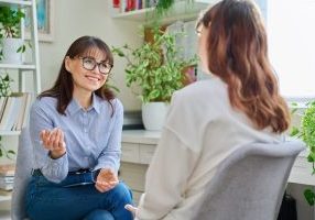 female psychologist counselor working young woman
