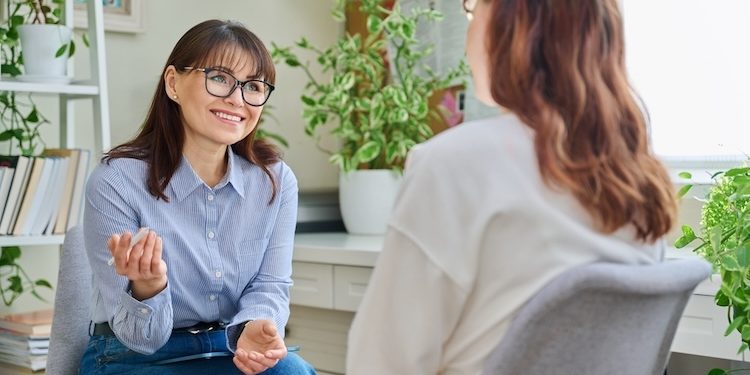 female psychologist counselor working young woman